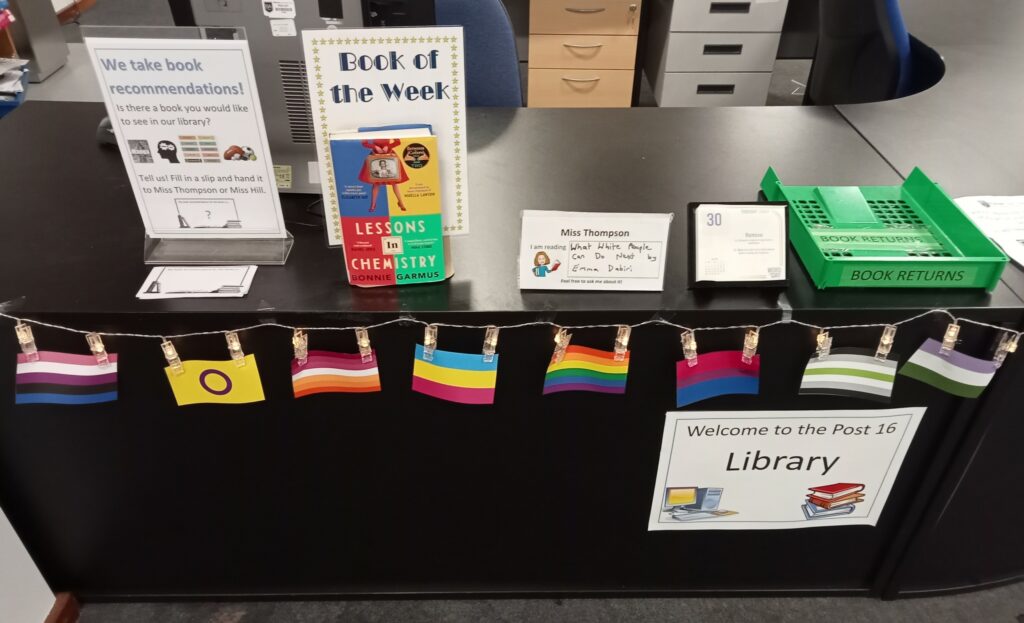 Library desk decorated with Pride Month flags